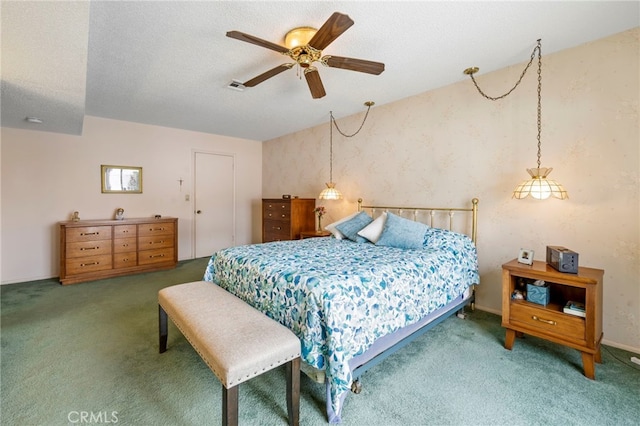 carpeted bedroom featuring ceiling fan and a textured ceiling