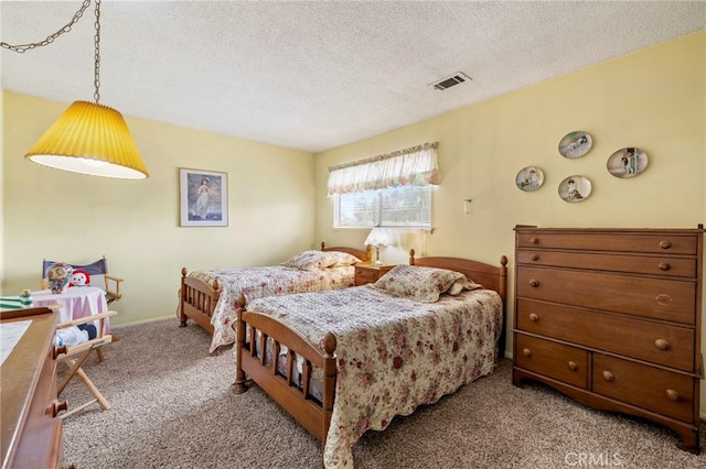 bedroom with light carpet and a textured ceiling