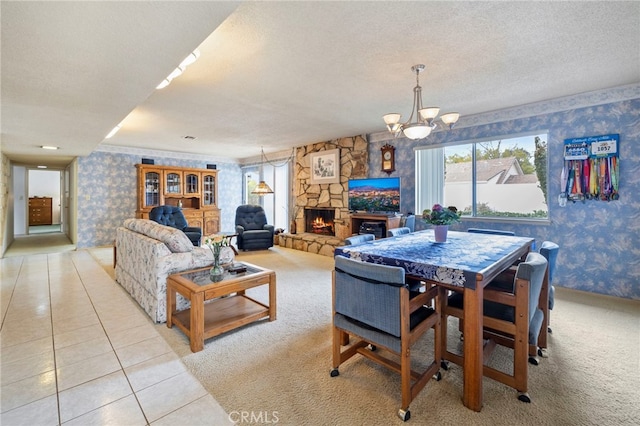 dining space featuring light tile patterned flooring, a stone fireplace, a textured ceiling, and a notable chandelier