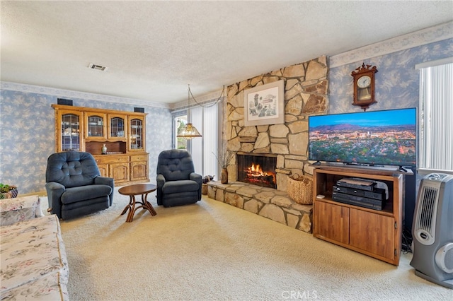 living room with a stone fireplace, light carpet, and a textured ceiling