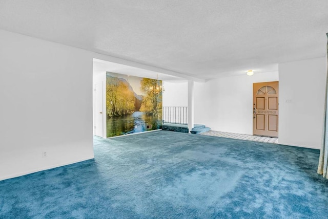 carpeted empty room featuring a notable chandelier