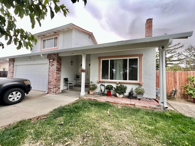 view of front of house with a garage, covered porch, and a front lawn