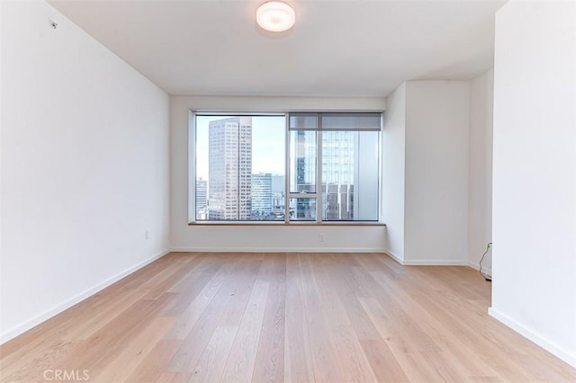 spare room featuring light hardwood / wood-style flooring