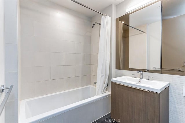 bathroom with tile walls, vanity, and shower / tub combo with curtain