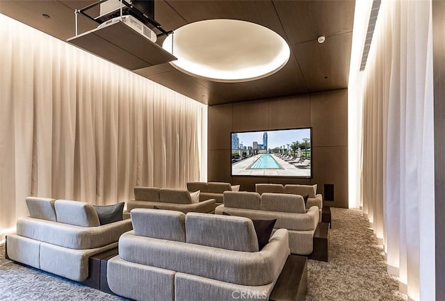 home theater featuring carpet and wood walls