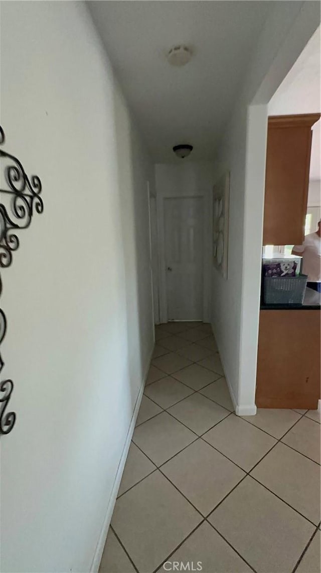 hall with light tile patterned flooring