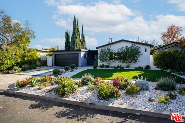 view of front facade with a front yard and a garage