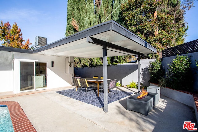 view of patio / terrace with cooling unit and an outdoor fire pit