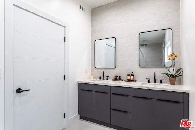 bathroom with vanity and tile walls