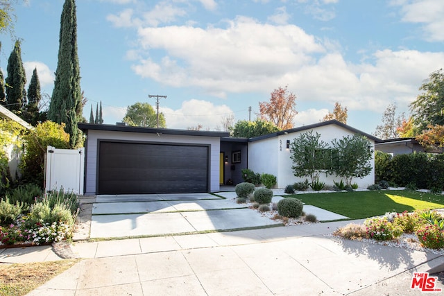 view of front of home with a front lawn and a garage