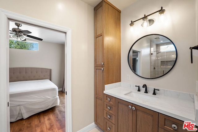 bathroom featuring a shower, wood-type flooring, vanity, and ceiling fan