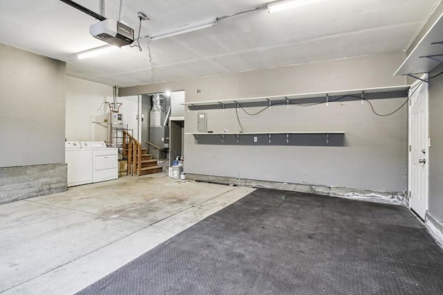 garage with a garage door opener and washing machine and clothes dryer