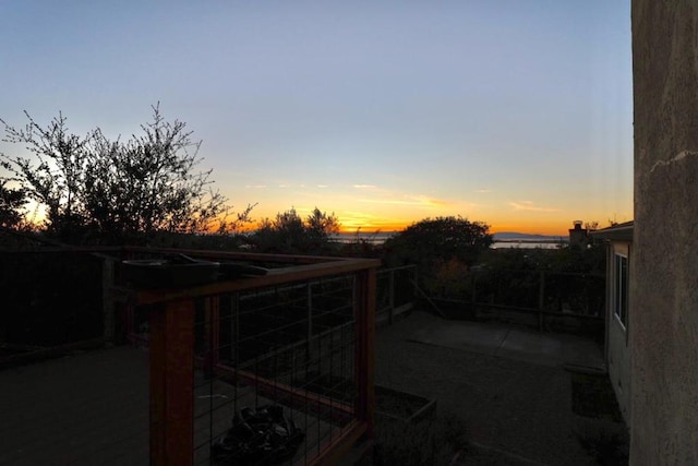 yard at dusk featuring a patio area