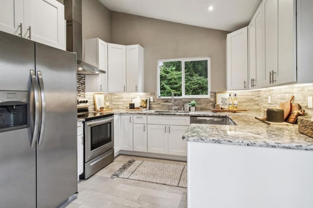 kitchen featuring white cabinetry, sink, wall chimney exhaust hood, and appliances with stainless steel finishes