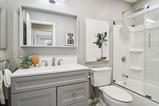 full bathroom featuring vanity, toilet, and combined bath / shower with glass door