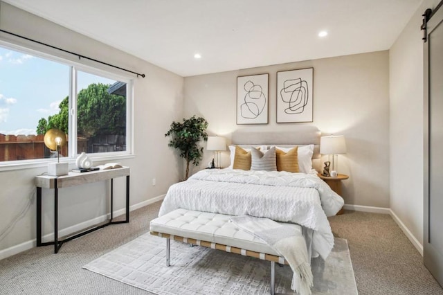 carpeted bedroom with a barn door