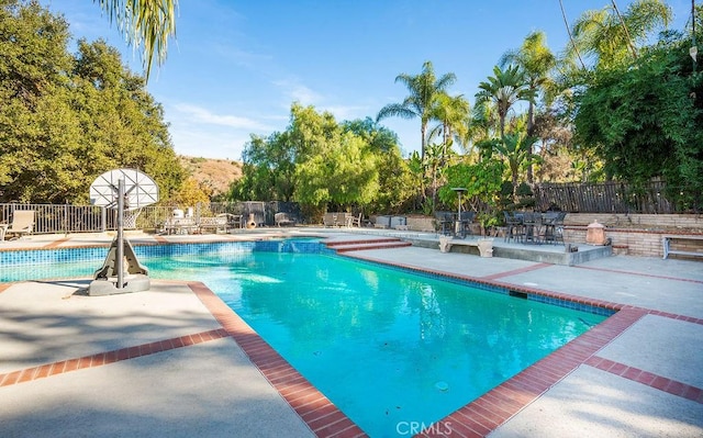 view of pool featuring a patio area and a mountain view