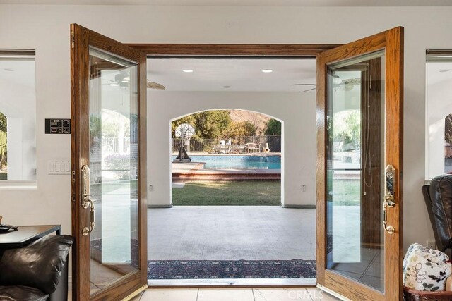 entryway with light tile patterned floors and french doors