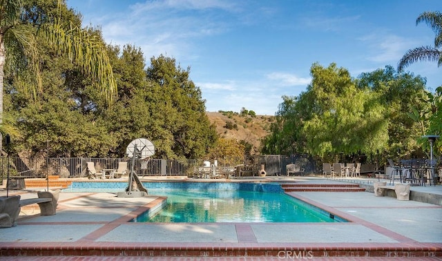 view of swimming pool featuring a patio area