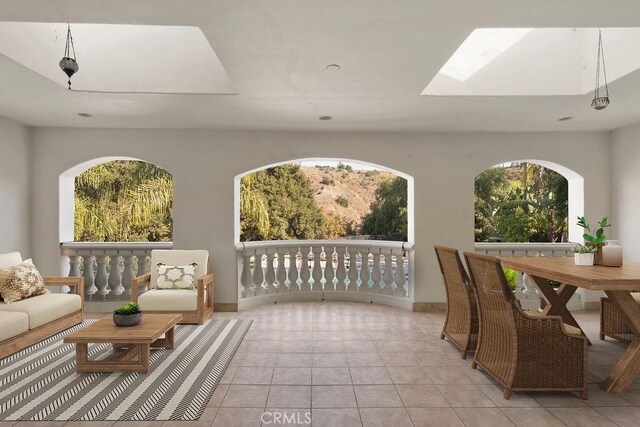 interior space featuring a skylight and light tile patterned flooring