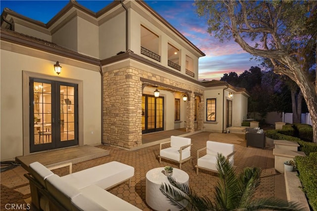 exterior space featuring french doors and an outdoor living space