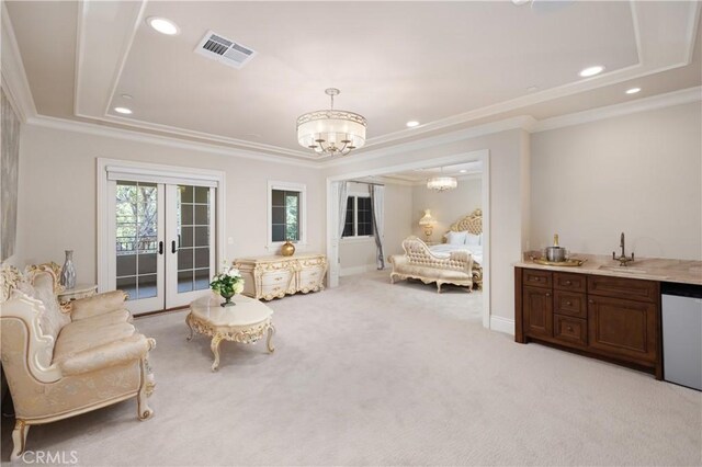 sitting room with light carpet, an inviting chandelier, a raised ceiling, french doors, and sink