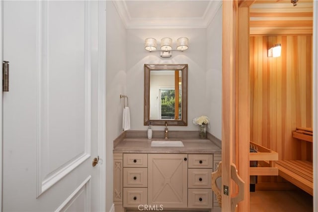 bathroom featuring ornamental molding and vanity