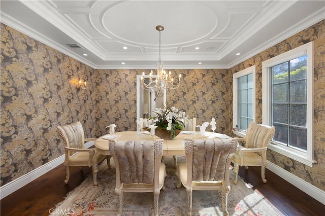 dining room with dark hardwood / wood-style flooring, crown molding, and a notable chandelier