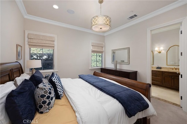 bedroom featuring connected bathroom, crown molding, and light colored carpet