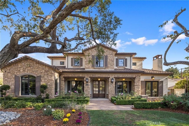 view of front facade featuring a front lawn and french doors