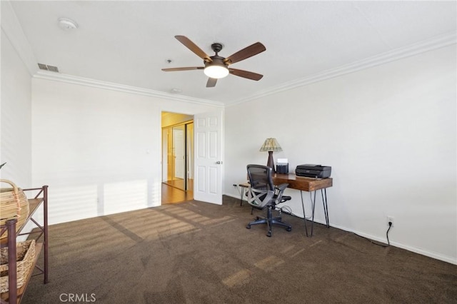 unfurnished office with baseboards, dark carpet, visible vents, and crown molding