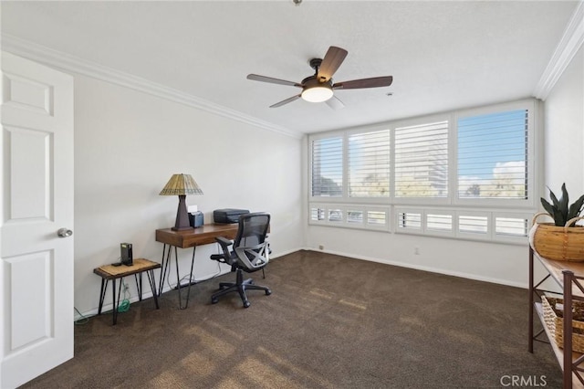 office space featuring a wealth of natural light, baseboards, dark colored carpet, and crown molding