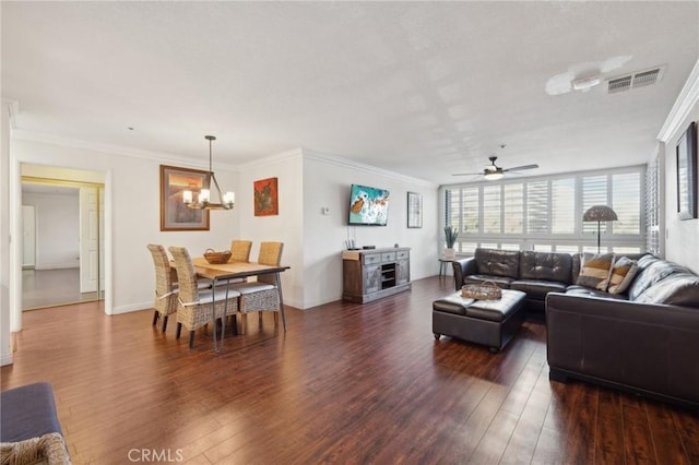 living area featuring ornamental molding, dark wood-type flooring, visible vents, and baseboards