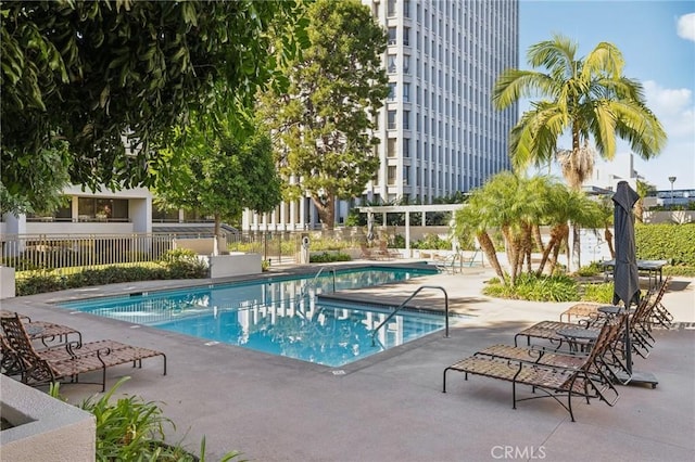 pool featuring a patio and fence