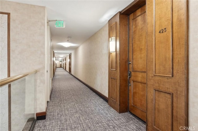 hall featuring carpet floors and baseboards