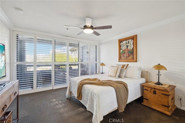 bedroom with ornamental molding, dark carpet, and a ceiling fan