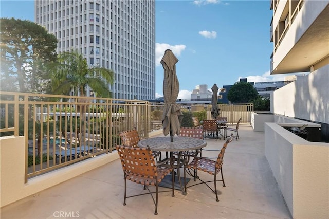 view of patio featuring a view of city and outdoor dining space