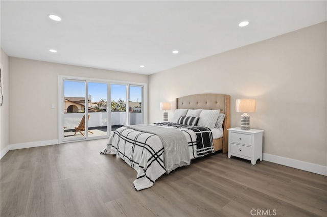 bedroom with access to outside and hardwood / wood-style floors