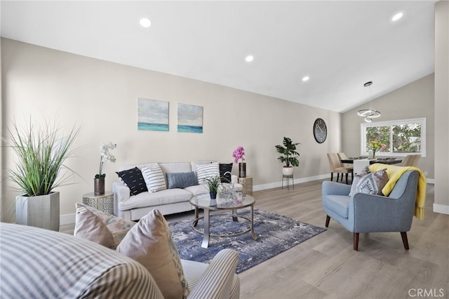 living room featuring lofted ceiling and light wood-type flooring