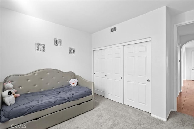 carpeted bedroom with a closet