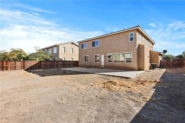 back of house with a patio and central AC unit