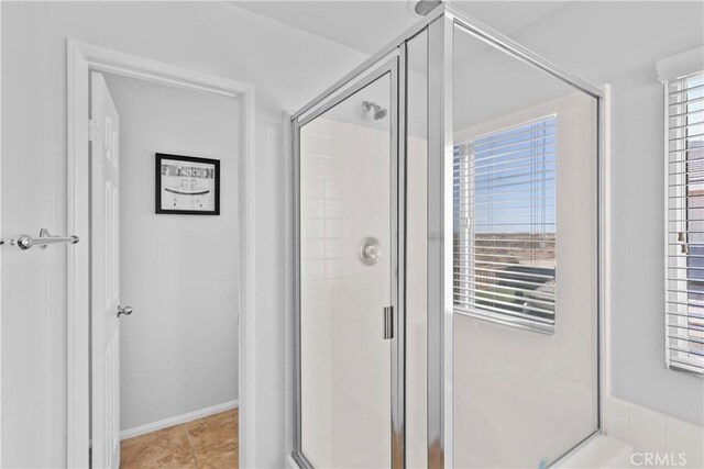 bathroom with tile patterned floors and an enclosed shower