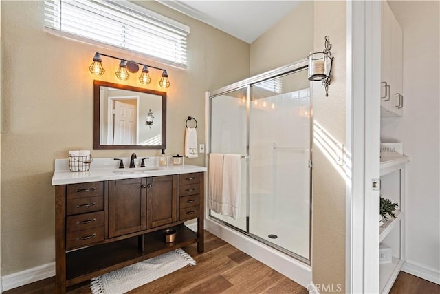 bathroom featuring a shower with door, vanity, and hardwood / wood-style flooring