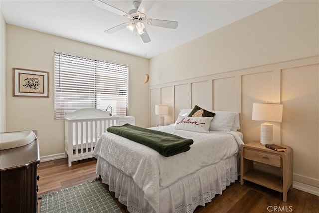 bedroom with ceiling fan and dark hardwood / wood-style floors