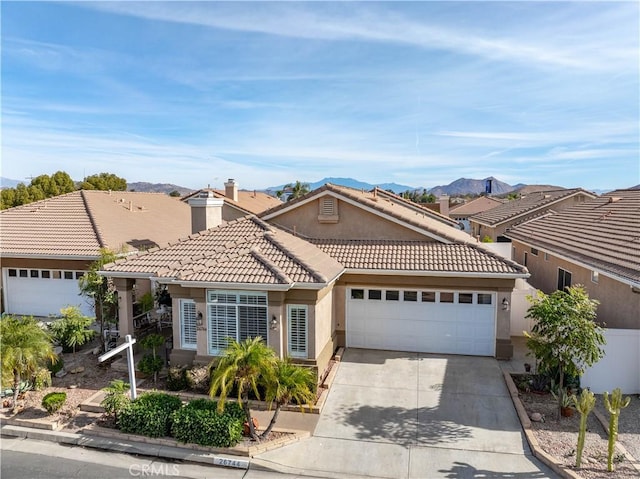 view of front of house with a mountain view and a garage