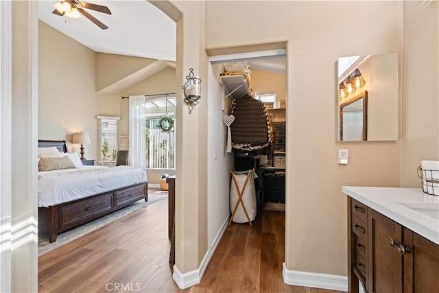 bedroom with light wood-type flooring, ceiling fan, and lofted ceiling