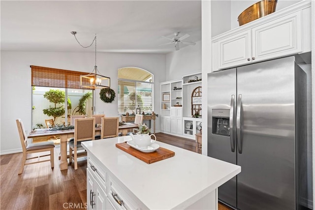 kitchen featuring lofted ceiling, white cabinetry, stainless steel fridge with ice dispenser, and dark wood-type flooring