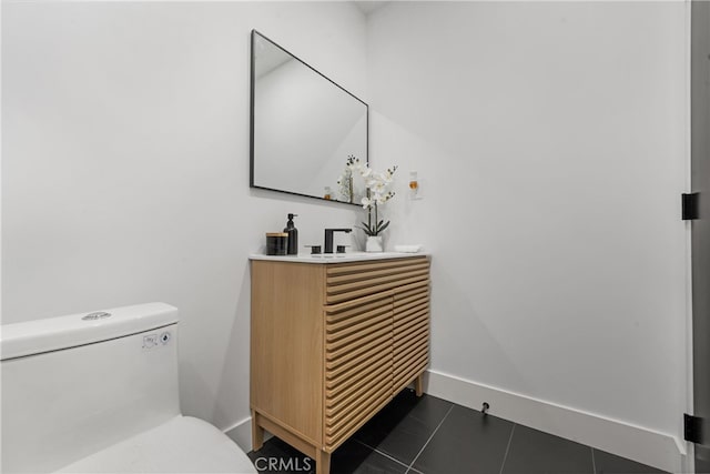 bathroom with tile patterned flooring, vanity, and toilet