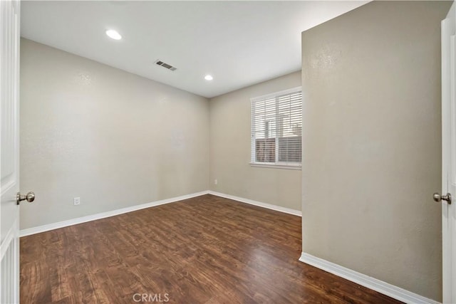 unfurnished room featuring dark wood-type flooring