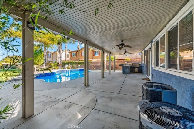 view of pool featuring ceiling fan, central air condition unit, exterior kitchen, and a patio